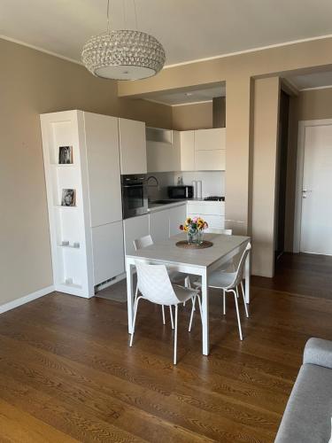 a kitchen and dining room with a table and chairs at Morivione Apartment - Bocconi free parking in Milan