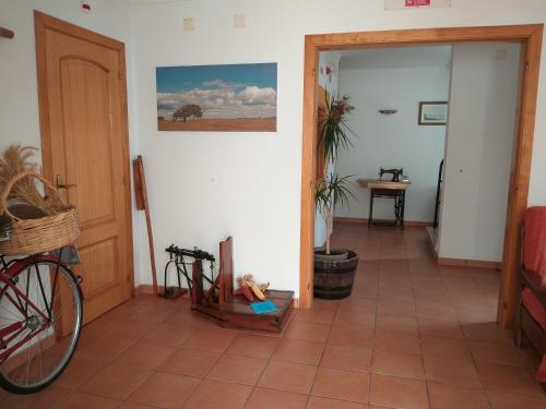 a hallway with a bike parked in a room at Sol da Vila in Vila Nova de Milfontes