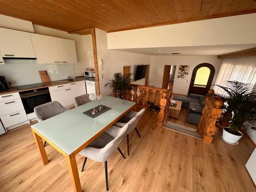 a kitchen and living room with a table and chairs at Apartments Katarina in Fieberbrunn