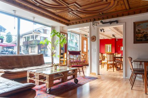 a living room with a couch and a table at Balmers Hostel in Interlaken