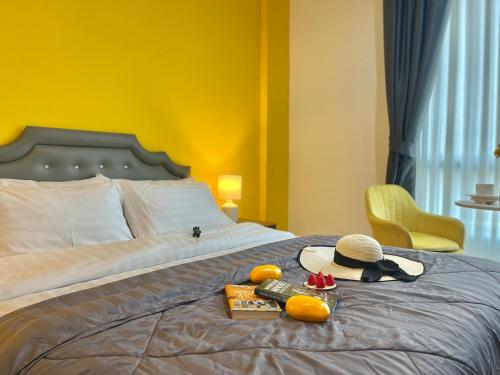 a bed with a hat and other items on it at Studio room in Mango House in Phuket Town
