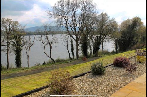 a view of a body of water with trees at Bluebell lake house in Enniskillen