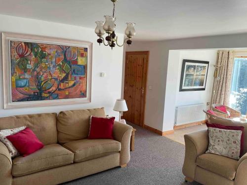 a living room with a couch and two chairs at Bluebell lake house in Enniskillen