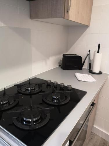 a kitchen with a black stove top in a kitchen at Vue mer, au calme, avec jardin ! in Spéracèdes