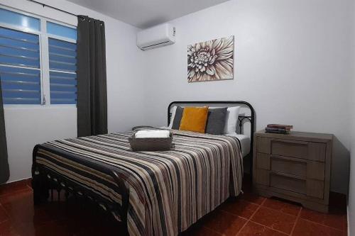 a bedroom with a bed and a dresser and a window at Casa Rosairis 