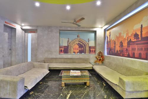 a living room with two couches and a table at HOTEL SURYAKANT in Rajkot