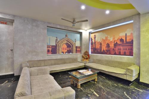 a living room with a couch and a table at HOTEL SURYAKANT in Rajkot