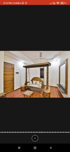 a picture of a living room with a bed at HOTEL SURYAKANT in Rajkot