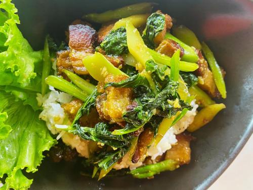 a plate of food with vegetables and rice and lettuce at Devi Kampot Resort at Phum Kampot in Kampot