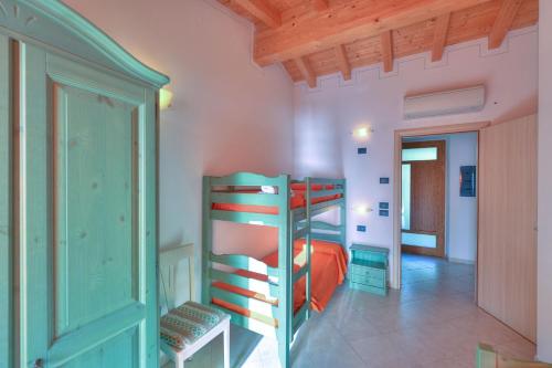 a bedroom with two bunk beds in a room at Agriturismo L'Uliveto in Gargnano