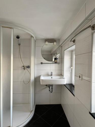 a bathroom with a sink and a shower at Gästezimmer Limburg City in Limburg an der Lahn