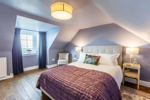 a bedroom with a large bed and a window at The Cock and Bull in Balmedie