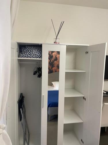 a white bunk bed with a blue bed in a room at Stella Rooms in Catania
