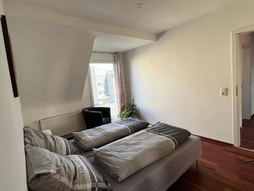 a living room with a couch with pillows on it at Gästezimmer Limburg City in Limburg an der Lahn