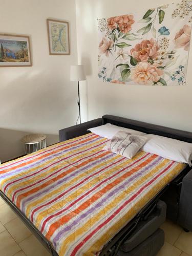 - un lit avec une couverture colorée dans l'établissement IULI LAKE HOME Tra lago e montagna, à Olginate