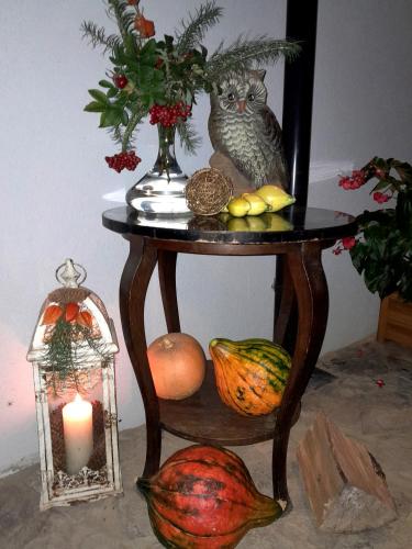 a table with a vase and a candle and fruit at Sowinka in Lutowiska