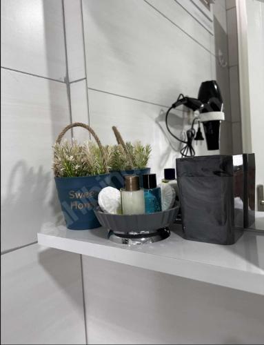 a shelf with two plants and a bag on it at Dokuz Otel in Samsun