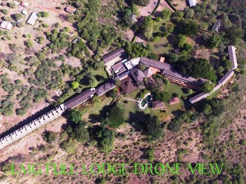 an aerial view of a house and a train at Lake Manyara Wildlife Lodge in Mto wa Mbu