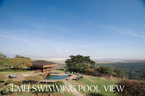 an aerial view of a swimming pool with a house at Lake Manyara Wildlife Lodge in Mto wa Mbu