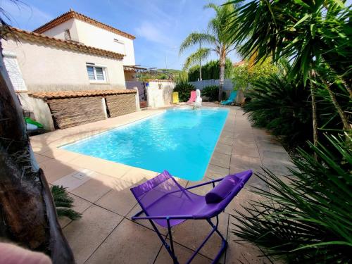 a purple chair sitting next to a swimming pool at Casa Leone 83 in Solliès-Pont