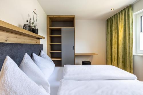 a bedroom with a bed with white pillows at Appartements Evers in Flachau