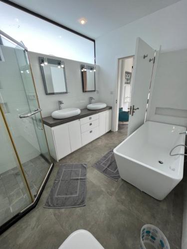 baño con 2 lavabos y espejo grande en Villa moderne à Trou aux Biches en Trou aux Biches