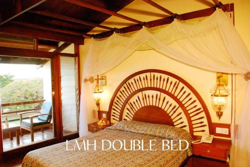 a bedroom with a large bed with a large at Lake Manyara Wildlife Lodge in Mto wa Mbu