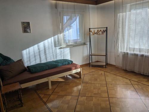 a living room with a couch and two windows at WaldHausen, kostenfrei WLAN und Netflix in Momlingen