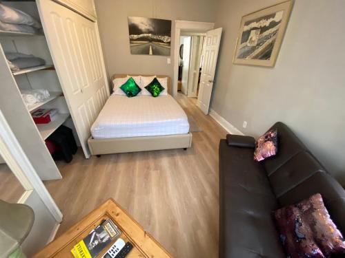 a living room with a bed and a couch at Cozy apt in WEST NY, NEW JERSEY, at 2 bloks from bus stop-15 minutes 2NY 7MINUTES VIA NYWATERWAY FERRY-BETTER CAN'T BE!! in West New York