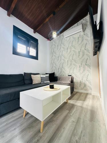 a living room with a couch and a coffee table at APARTAMENTO EL CUCHI in Sanlúcar de Barrameda