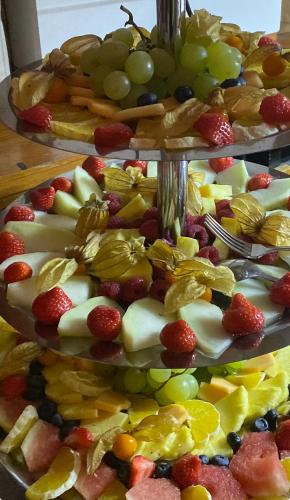 three plates of fruit and vegetables on a table at Hotel Schuetzenhaus Vorsfelde in Wolfsburg