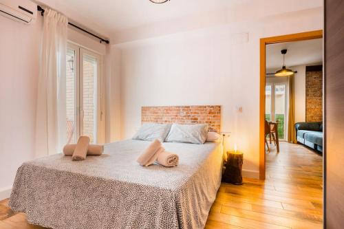 a bedroom with a bed with two pillows on it at Apto céntrico, 2 aparcamientos privados, bicis in Seville