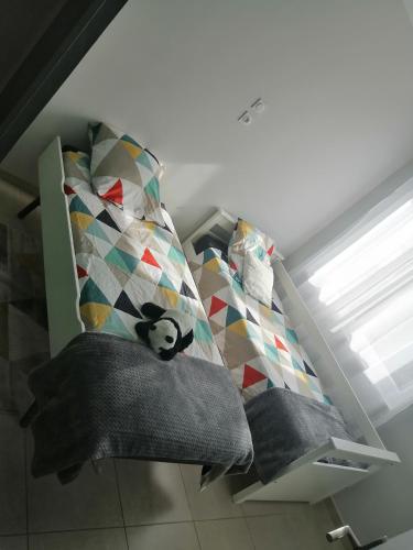 a bedroom with a bed with pillows and a window at Maison au pied des cévennes in Rousson