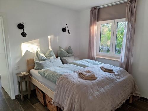 a bedroom with a bed with two towels on it at Haus Swanhild in Fockbek