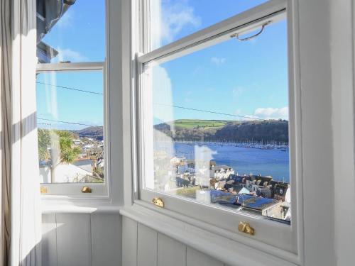 an open window with a view of a body of water at Dartmouth Cottage - River and Sea Views with Parking Permit in Dartmouth