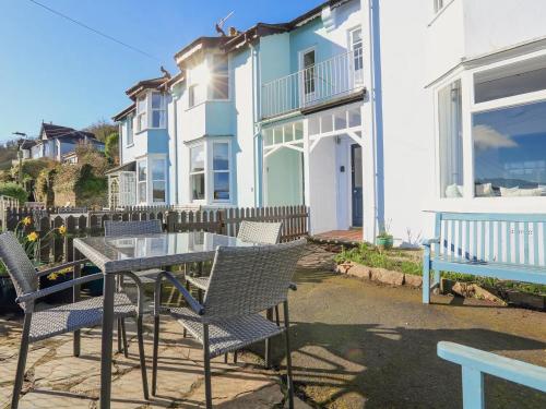 a table and chairs in front of a house at Dartmouth Cottage - River and Sea Views with Parking Permit in Dartmouth