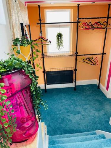 a room with stairs and a room with a plant at Colourful Apartment in Margate in Kent