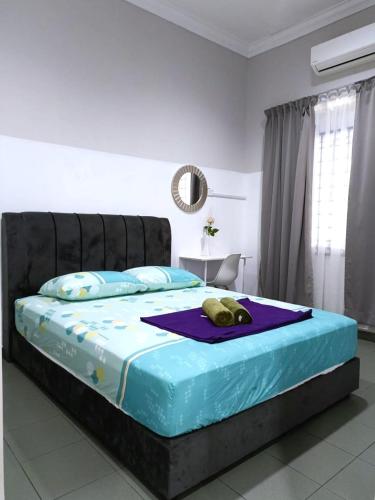 a bedroom with a bed with a stuffed animal on it at YK Homestay in Kulai