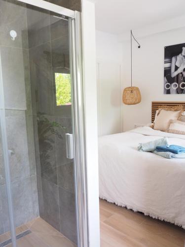 een slaapkamer met een douche en een bed bij Casa Narú Albir, duplex appartement met ruim terras en buitenkeuken in Albir