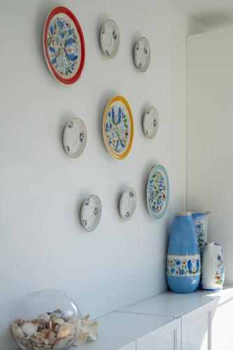 a room with clocks on the wall and a shelf at 4 Pory Roku Apartamenty Domki Pokoje in Nadole
