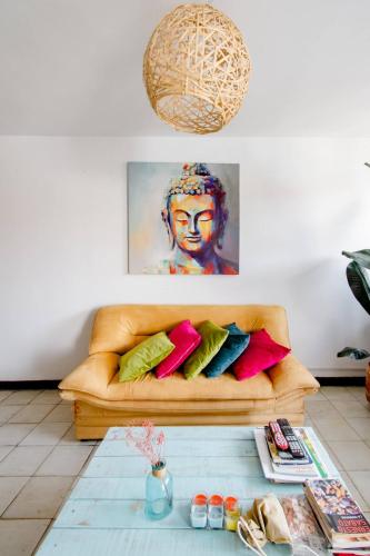 a room with a couch with a painting on the wall at Casa de Luz in Cali