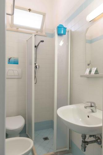 a bathroom with a sink and a toilet and a shower at Hotel Smart Cervia B&B in Cervia