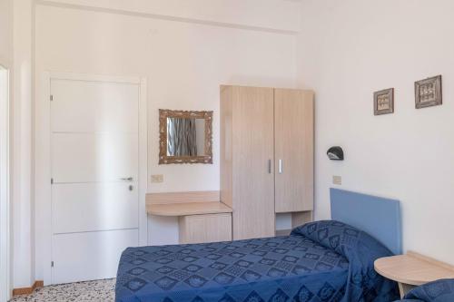 a bedroom with a blue bed and a cabinet at Hotel Smart Cervia B&B in Cervia