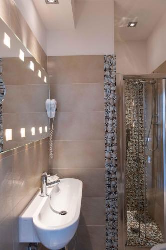 a bathroom with a sink and a shower at Hotel Smart Cervia B&B in Cervia