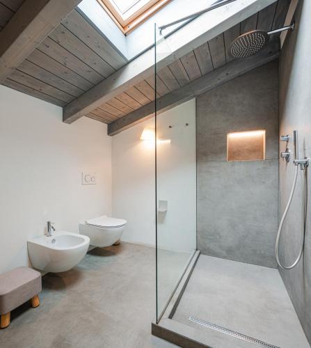 a bathroom with a glass shower and a sink at Nikis Resort in Gubbio
