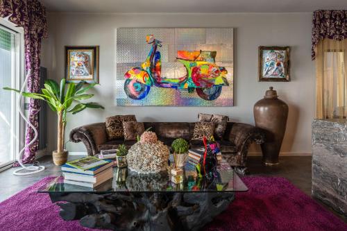 a living room with a couch and a table at Baba Residences in Alassio