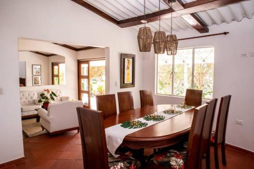 a dining room with a wooden table and chairs at Soare Country house in Zipaquirá