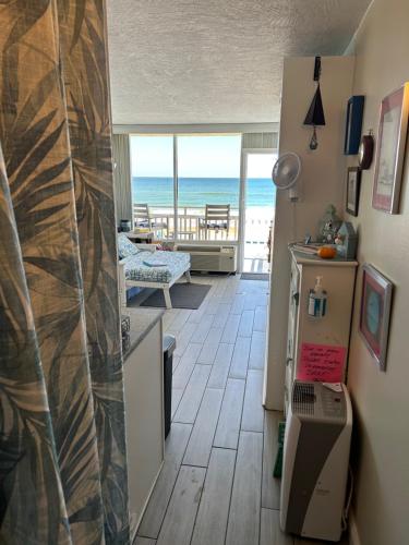 a kitchen with a view of the ocean from a room at OB Oceanfront Studio - closest to the beach in Ormond Beach