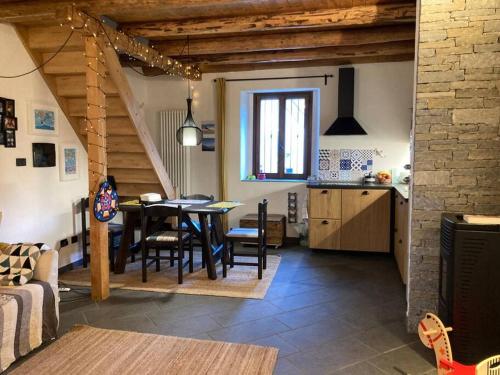 a kitchen and dining room with a table and chairs at Casa in pietra al lago di Como in Colico