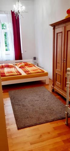 a bedroom with a bed and a rug at Tillyhome in Nürnberg